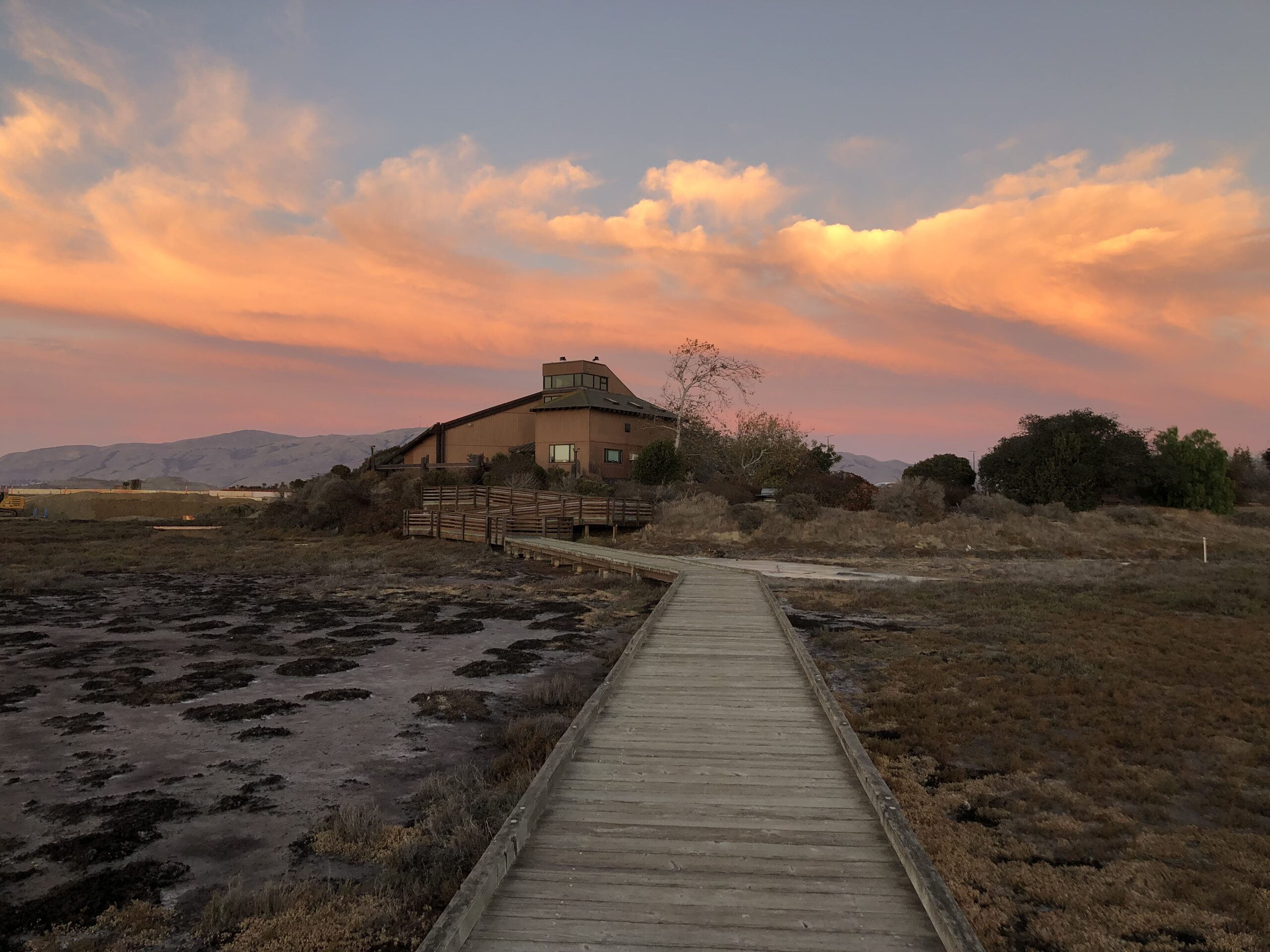 Environmental Education Center building and New Chicago Marsh Boardwalk at sunset