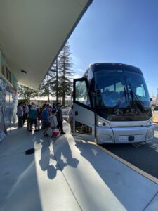 Children waiting in line to board a bus to attend our summer camp.