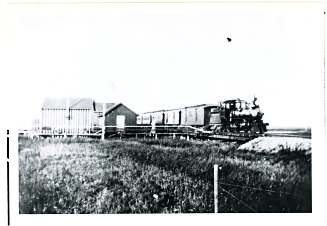 A modern Southern Pacific train heads north, across the Mud Slough bridge.