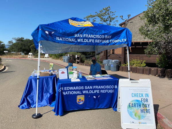 Volunteers running the Check-In Table at the Refuge's annual Earth Day Event in 2022.